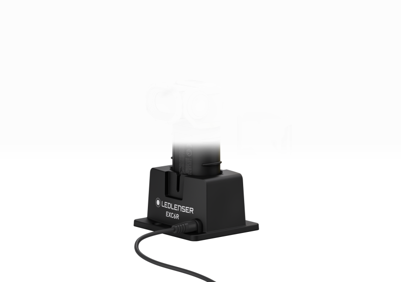 Three quarter front view of the charging station for the ultra-compact, yellow and black Ledlenser EXC6R rechargeable torch 