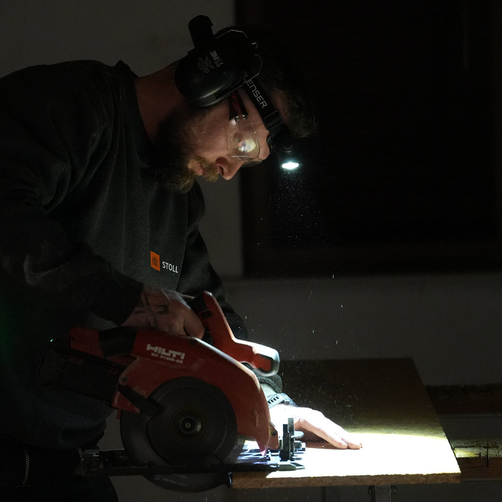 Worker wearing a Ledlenser headlamp to light his work area