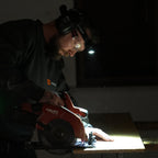 Worker wearing a Ledlenser headlamp to light his work area