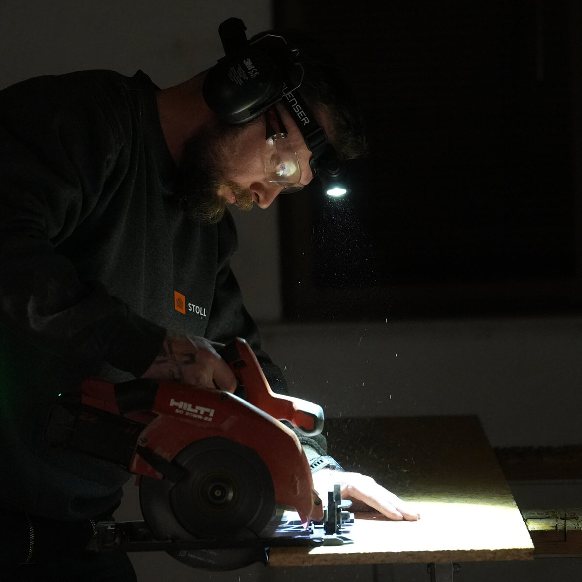 Worker wearing a Ledlenser headlamp to light his work area