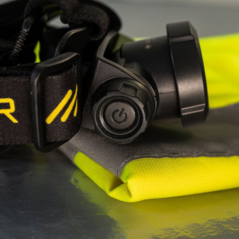 Close up of head of Ledlenser H15R Pro Headlamp sitting on hi-vis vest