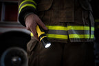 Firefighter using the Ledlenser EX7R rechargeable torch to light their way on the job