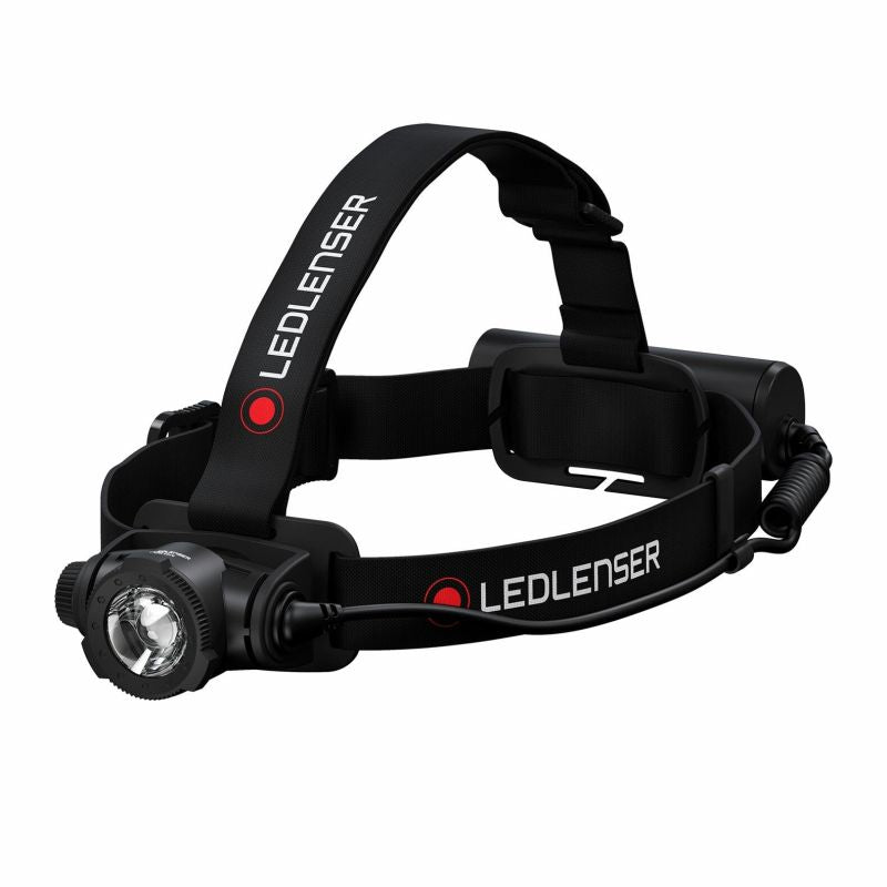 Front three quarter view of Ledlenser H7R Core rechargeable headlamp with red/black branded overhead strap and battery pack on back - Black