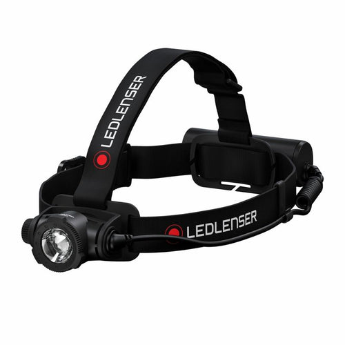 Front three quarter view of Ledlenser H7R Core rechargeable headlamp with red/black branded overhead strap and battery pack on back - Black