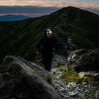 Person using Ledlenser H7R Core rechargeable headlamp to light the trail ahead of them
