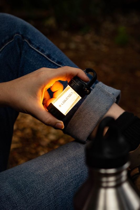 Person holding Ledlenser ML4 Warm Light Lantern while in camp at night