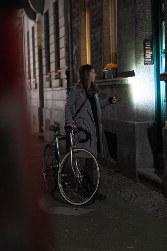 Person using Ledlenser K6R rechargeable Keyring Light to check doorway