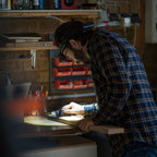 Person using Ledlenser H7R Core rechargeable headlamp to light their work space