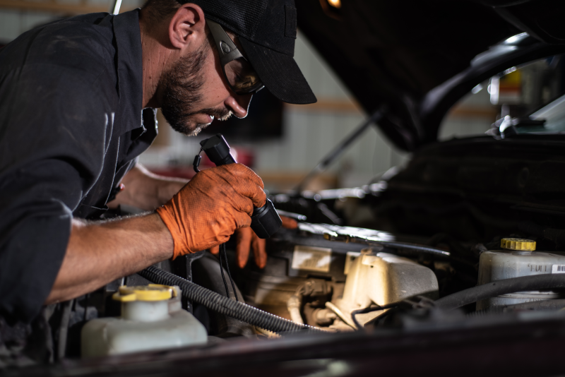 Image of mechanic using Ledlenser P5R Work Rechargeable Torch when looking under the hood