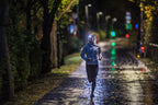 Image of person running along a city path at night