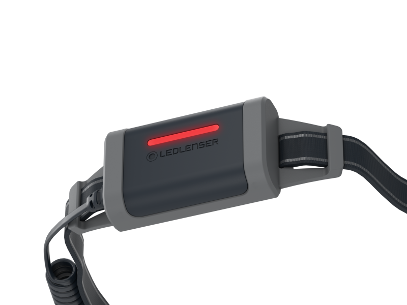 Close up of battery on Ledlenser NEO5R rechargeable headlamp with headband showing red flashing rear light. – Black/Grey
