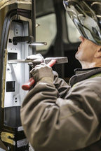 Workman using the Ledlenser W7R rechargeable work light with the light mounted to the work surface using the magnetic mounting option