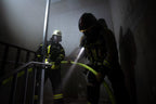 Firefighter shown using the Ledlenser EXC6R rechargeable torch on the job