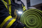 Firefighter using the Ledlenser ultra-compact, yellow and black EXC7R rechargeable torch while on the job