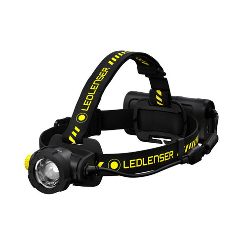 Three quarter front view of Ledlenser H15R Work rechargeable headlamp with yellow/black branded overhead strap and battery pack - Black
