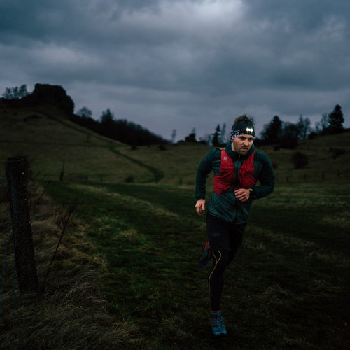 The Ledlenser NEO9R rechargeable headlamp with branded headband in action on a night run